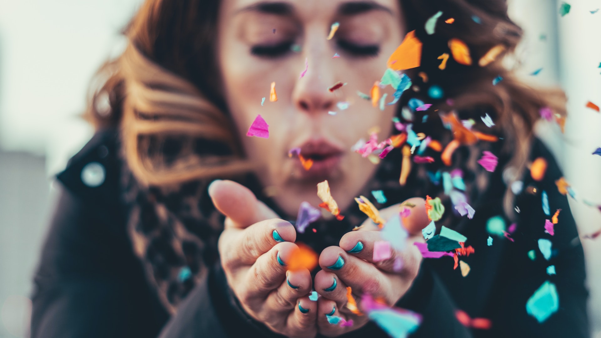 Liberty PRSSA Newsletter Event Planning Photo, girl blowing confetti out of her hands