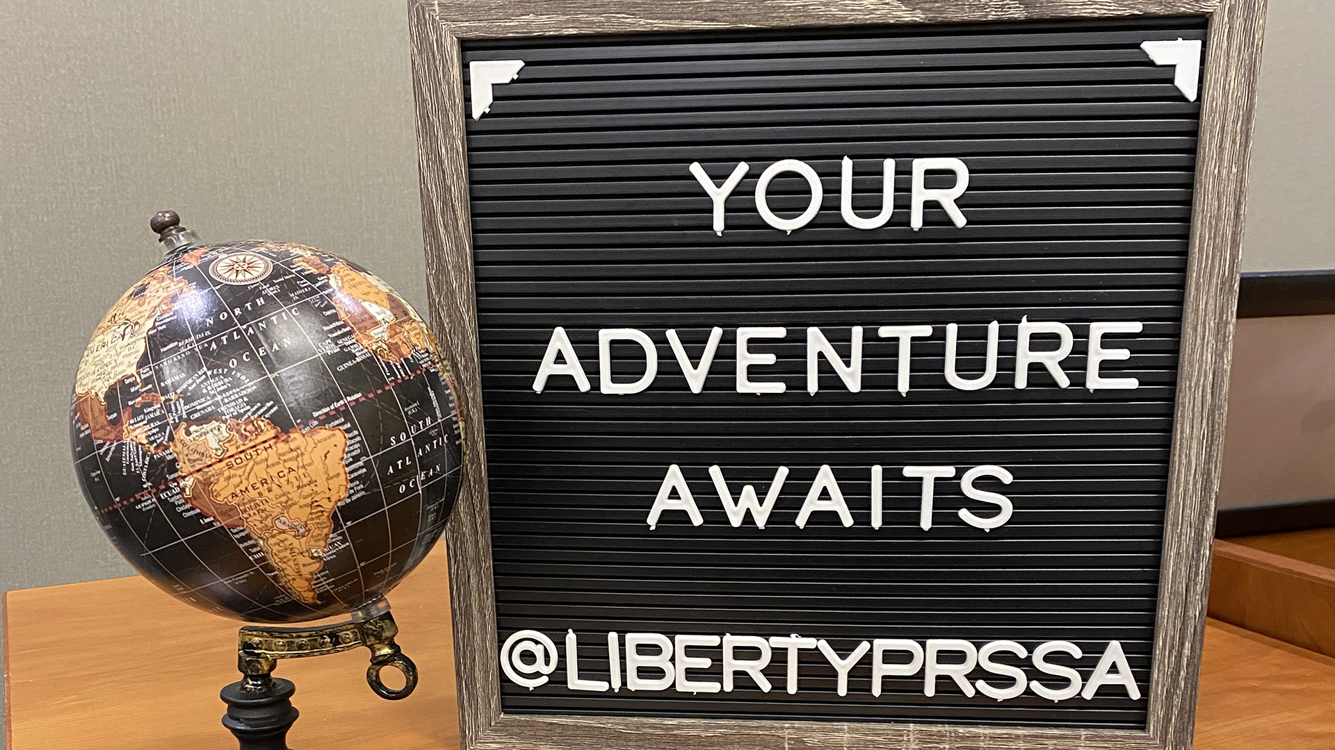 Liberty PRSSA Go Global Event photo with globe and inspirational quote