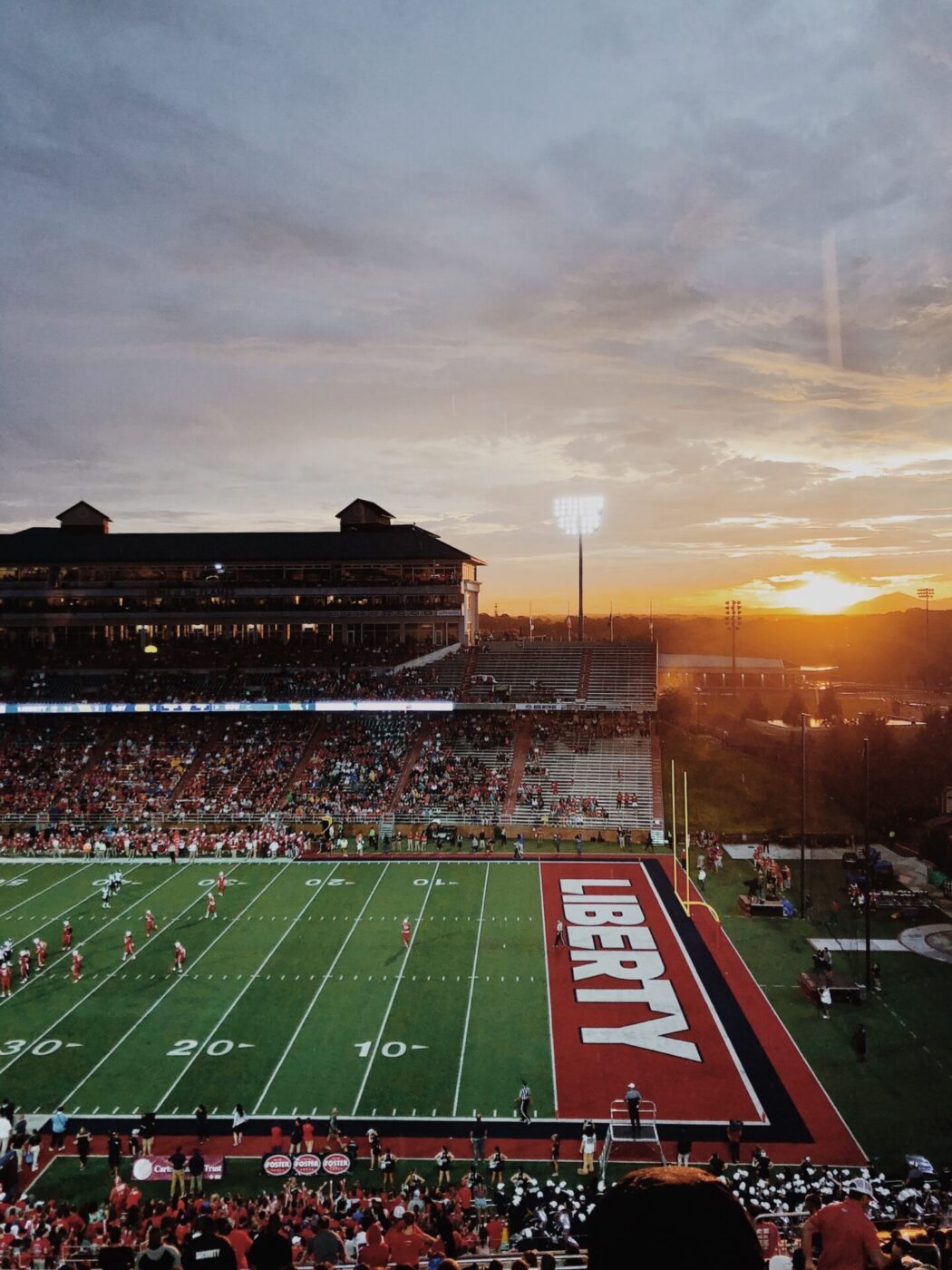 Liberty University football field, Williams Stadium, at sunset. View of the Blue Ridge Mountains in Virginia.